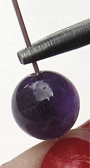 glass bead placed on eye pin