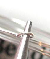 using pliers to bend loop in memory wire using pliers to bend loop in memory wire